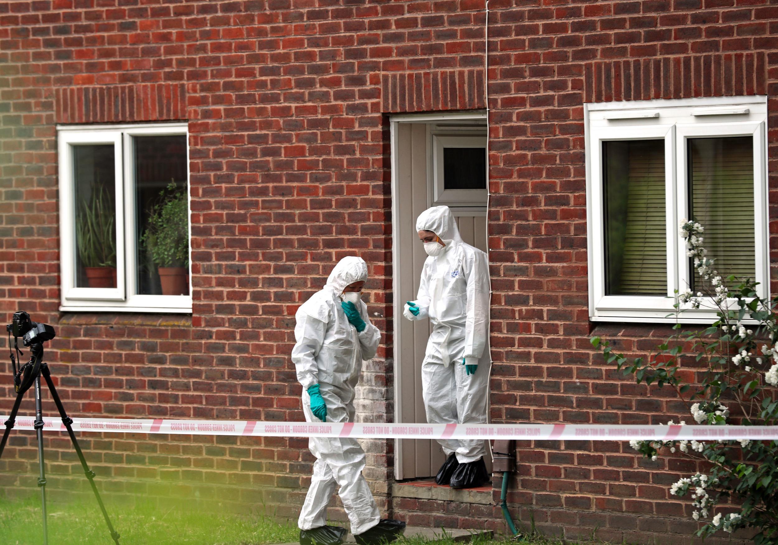 Forensics officers at the Hanworth, west London home where an 11-month-old baby and a woman were stabbed