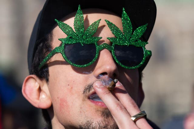 A man smokes marijuana during the annual 4/20 rally on Parliament Hill in Ottawa, Ontario