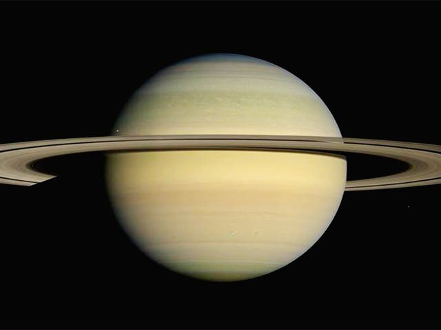 Saturn is girdled by brilliant appendages that would stretch almost all the way from the Earth to the Moon