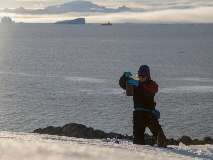 Sandra Schoettner, marine biologist and oceans campaigner with Greenpeace Germany, takes snow samples to investigate the presence of persistent organic pollutants