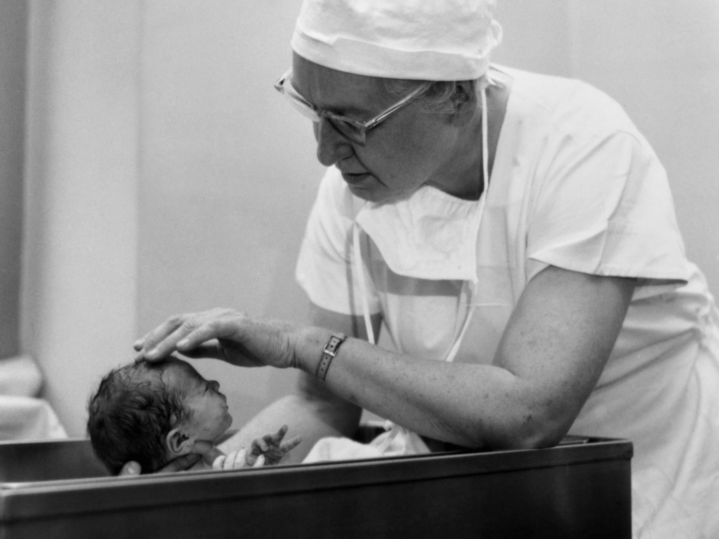 Virginia Apgar examining a newborn baby