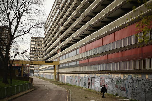 boy walks through the Heygate Estate in the Walworth area on April 24, 2013 in London, England. The Heygate estate in central London was built in 1974 as social housing and housed around 3000 people, but fell into a state of disrepair, gaining a reputation for crime and poverty