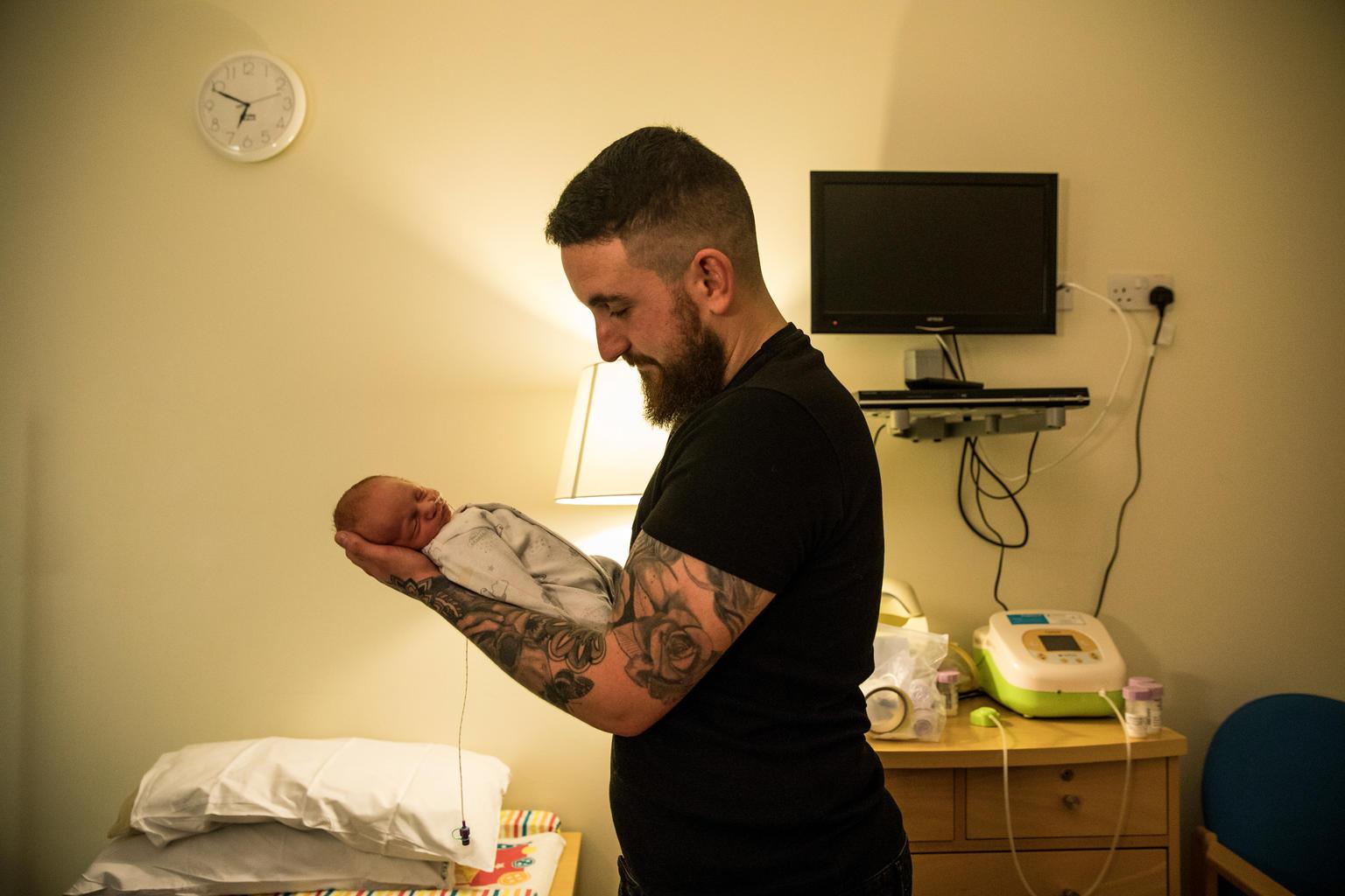 Alex Edmonds Brown holds his son Harley James, in a private room in the maternity ward of the Royal Devon and Exeter Hospital in Devon