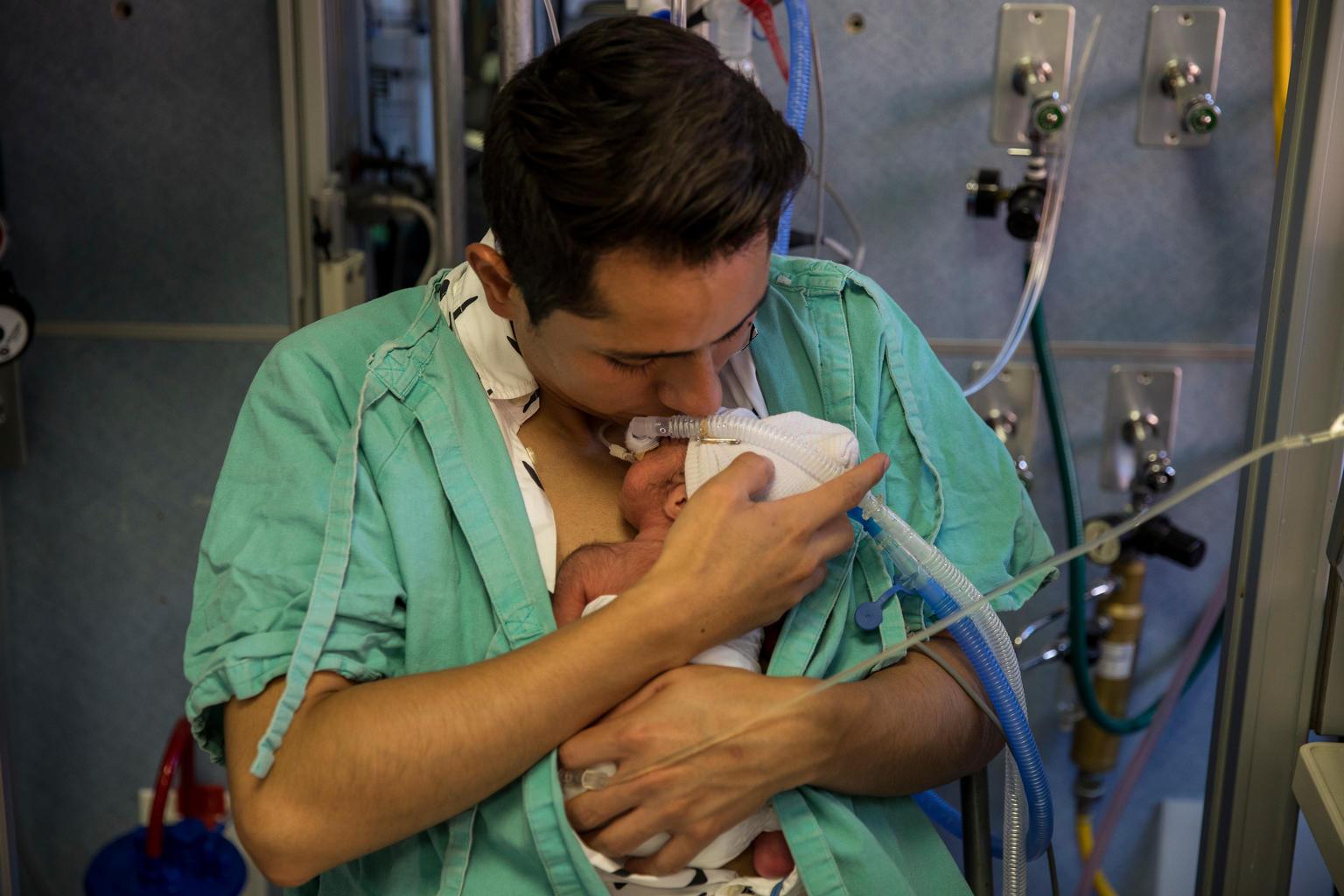 Rogelio Cruz Barrera holds one of his twins born prematurely, a baby girl named Ximena, in Mexico City