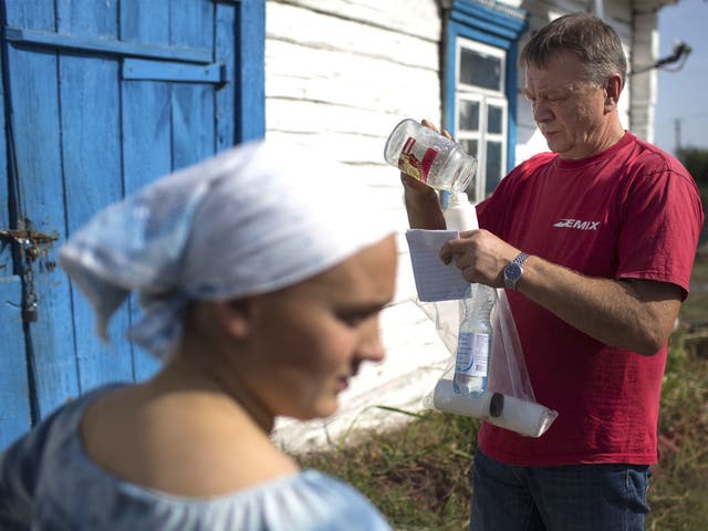 Dr Mykola Lazarev of the Ukrainian Institute of Agricultural Radiology examines milk as part of the study