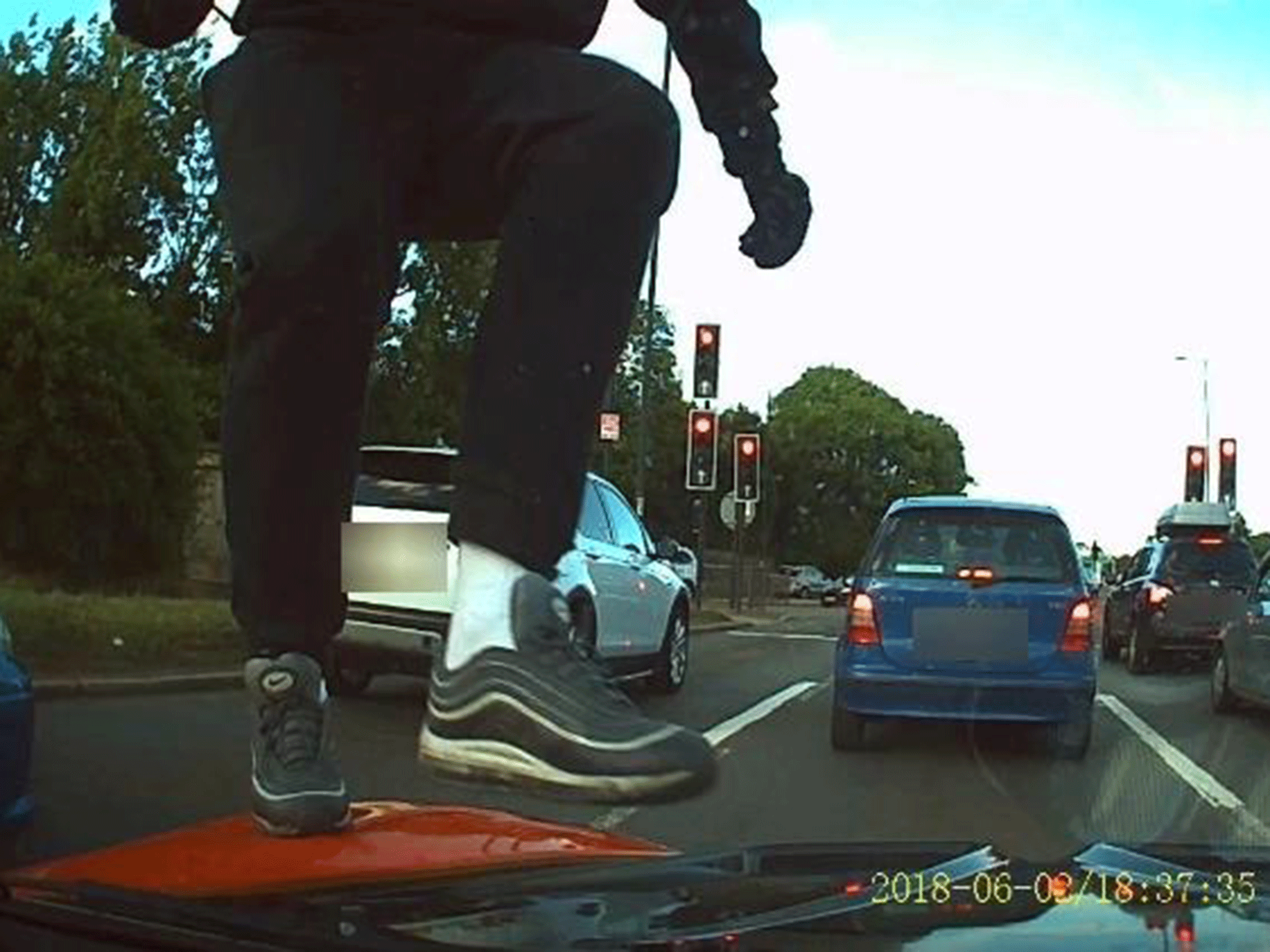 A dashcam image showing an attack by moped robbers on a car in Finchley on Saturday
