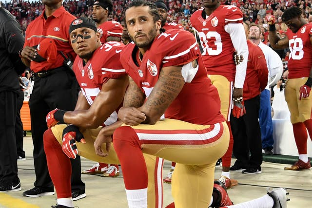 Colin Kaepernick (right) and Eric Reid of the San Francisco 49ers kneel in protest during the national anthem prior to an NFL game in Santa Clara, California