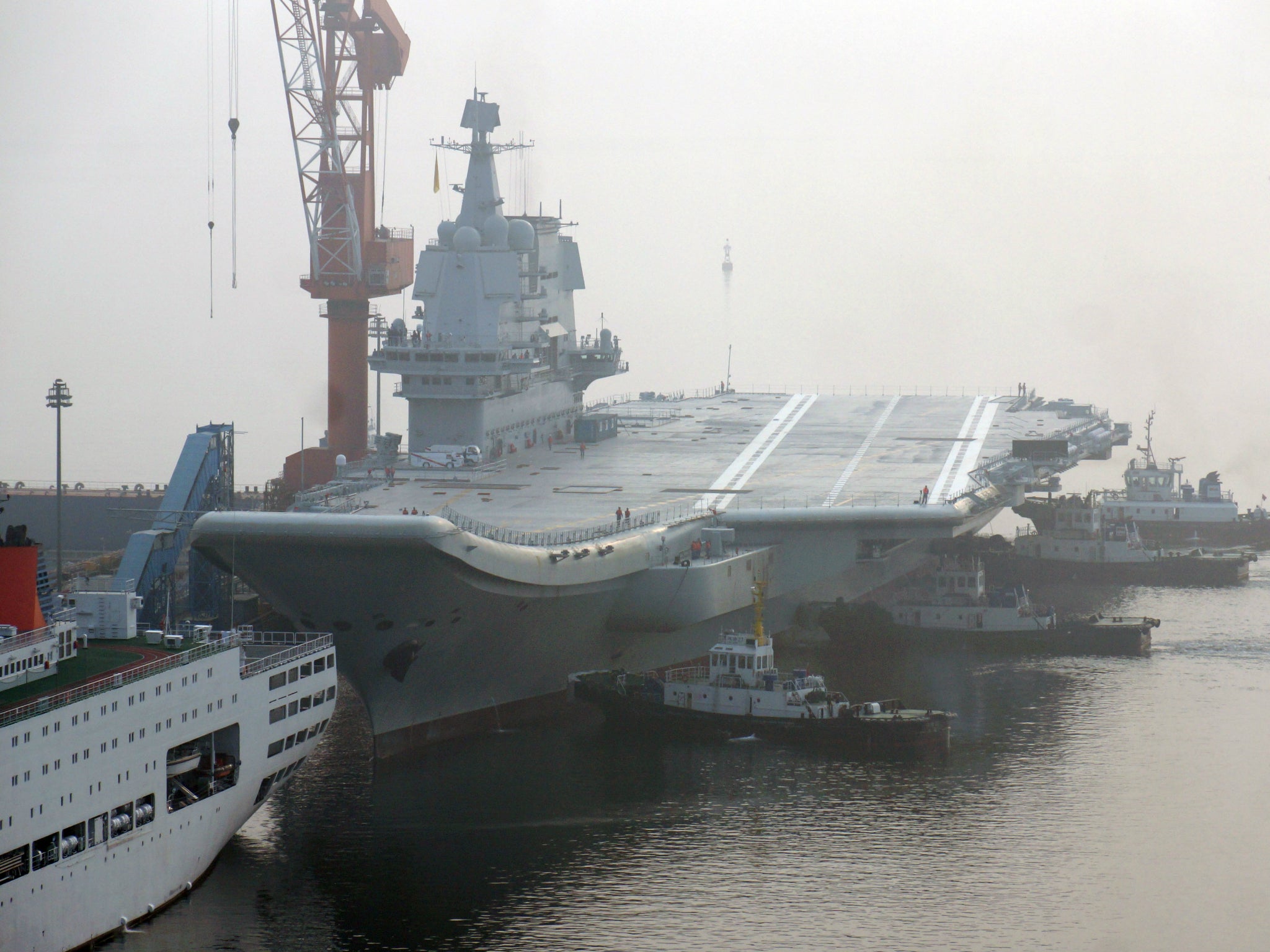 China's first home-built aircraft carrier sets out from a port of Dalian for sea trials on 13 May 2018