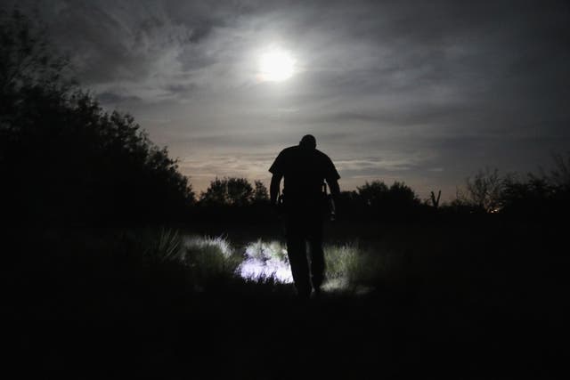 A US Border Patrol supervisor tracks undocumented immigrants under a full moon