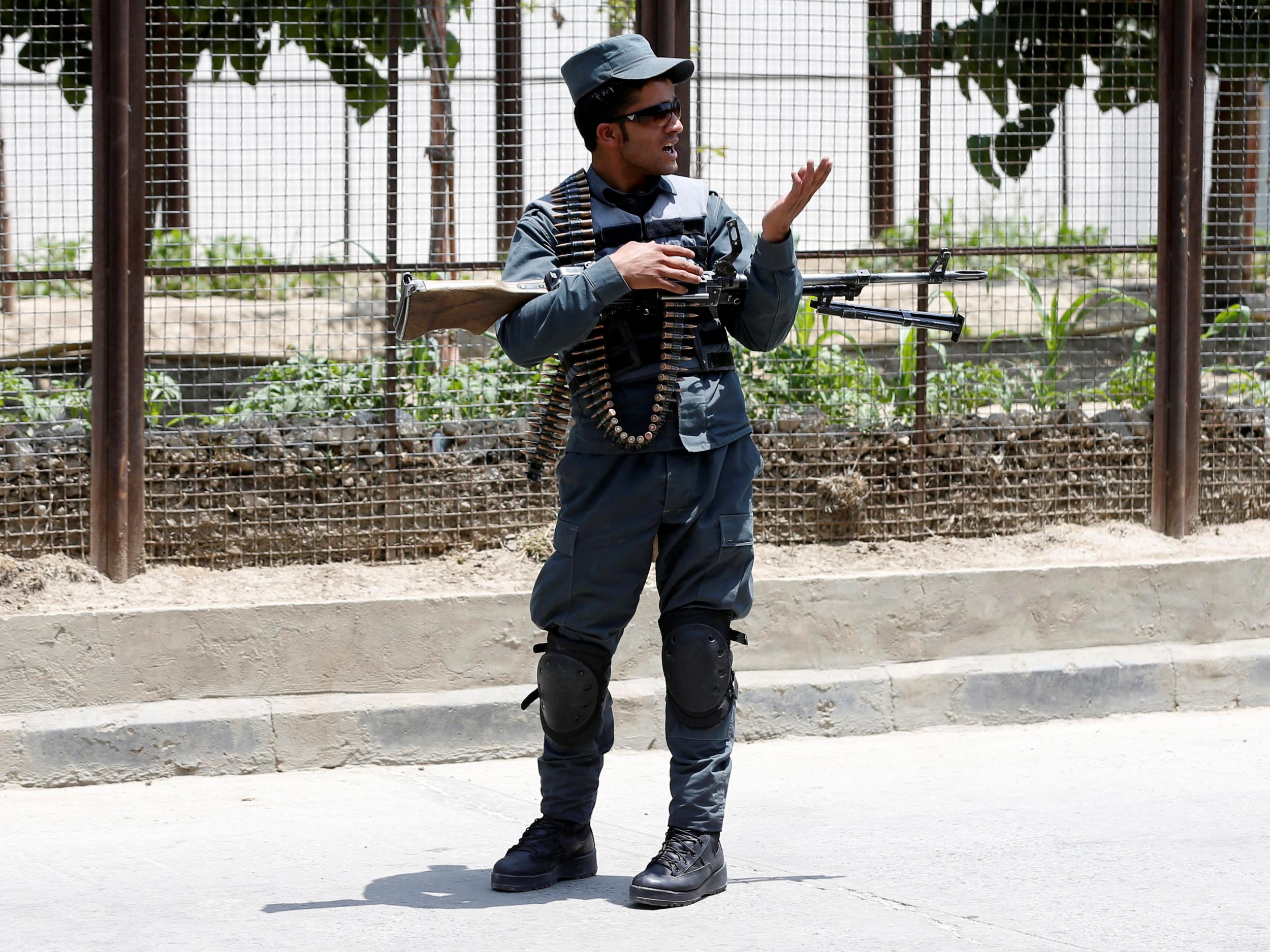 An Afghan police officer keeps watch at the site of a suicide attack in Kabul this week