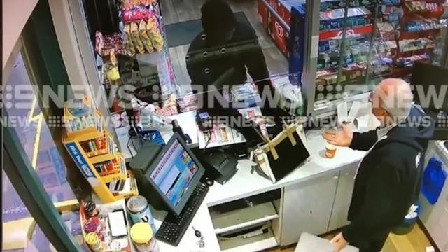 The robber discharged the gun, narrowly missing the worker