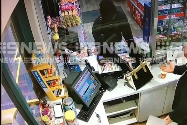 The robber discharged the gun, narrowly missing the worker