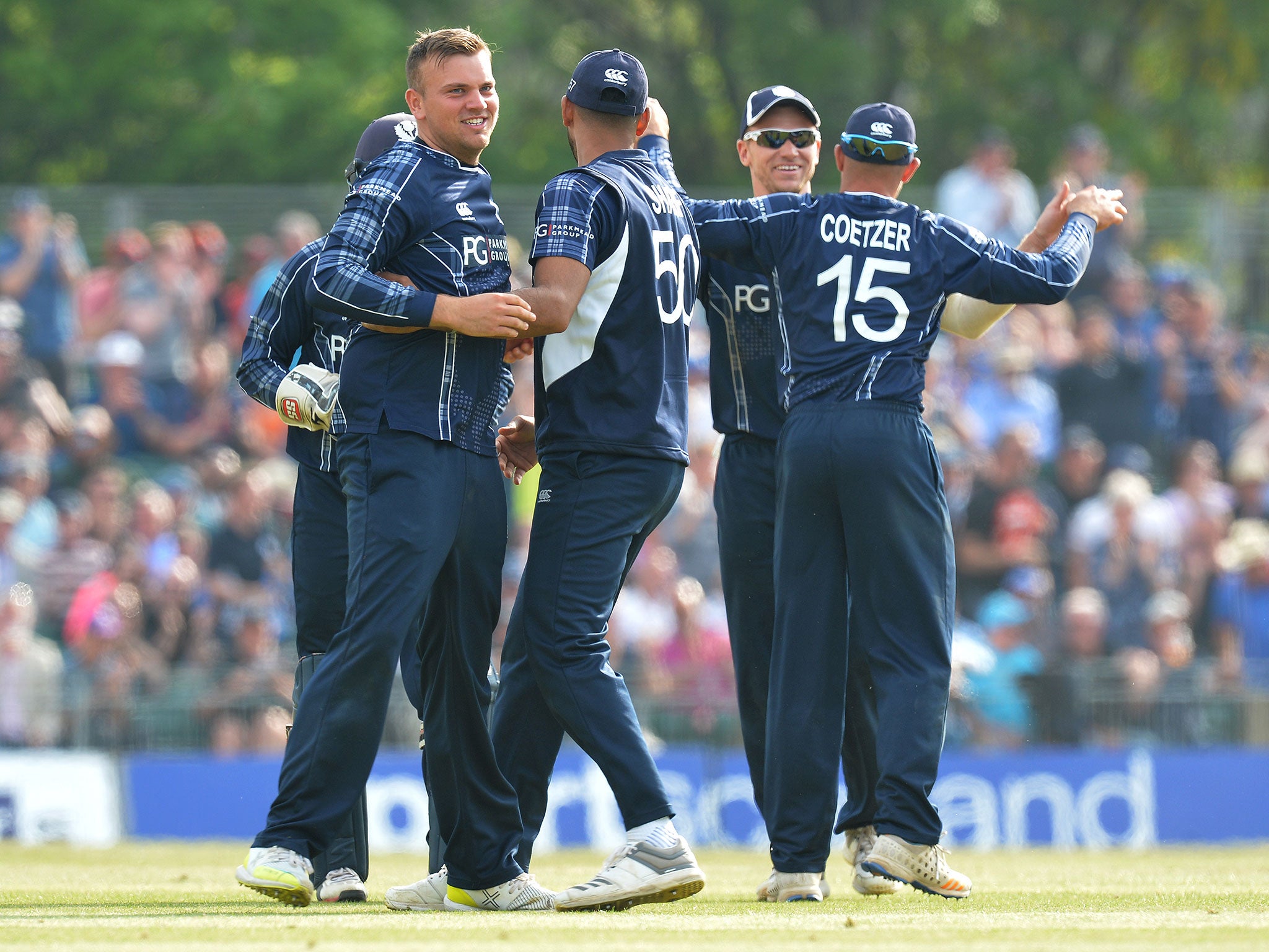 Mark Watt celebrates with his team mates after taking the wicket of Sam Billings