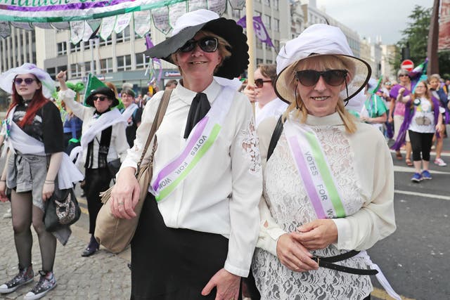 Women dressed as suffragettes take part in the Processions' artwork march, in Belfast, as they mark 100 years since the Representation of the People Act