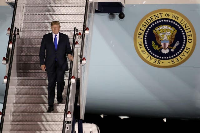 Donald Trump arrives aboard Air Force One at Paya Lebar Air Base in Singapore