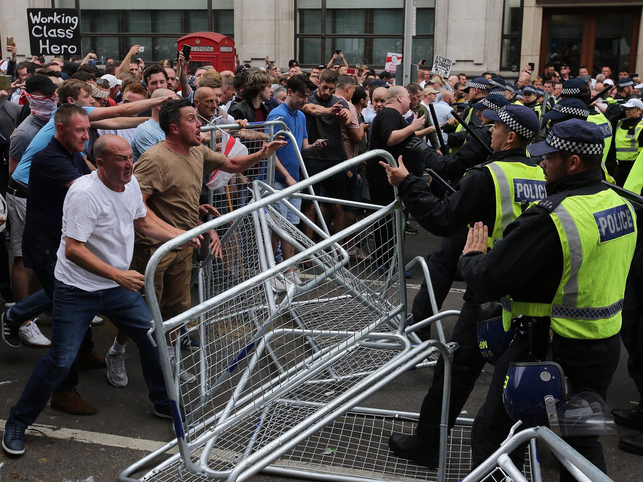 Protesters scuffle with police at the junction of Whitehall and The Mall during a ‘Free Tommy Robinson’ protest on 9 June (AFP/Getty)