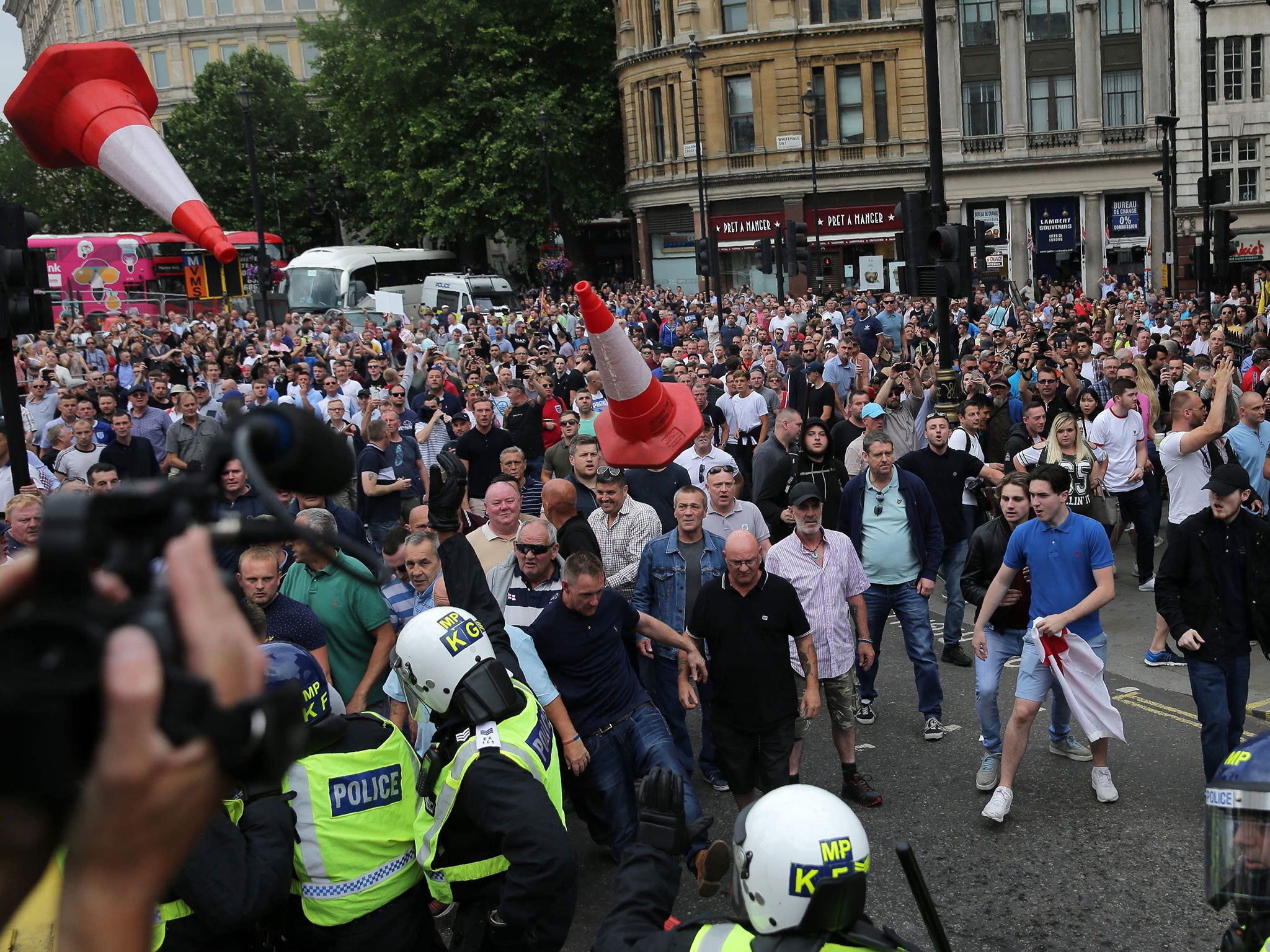 Traffic cones fly as protesters scuffle with police at the junction of Whitehall and The Mall during a 'Free Tommy Robinson' protest