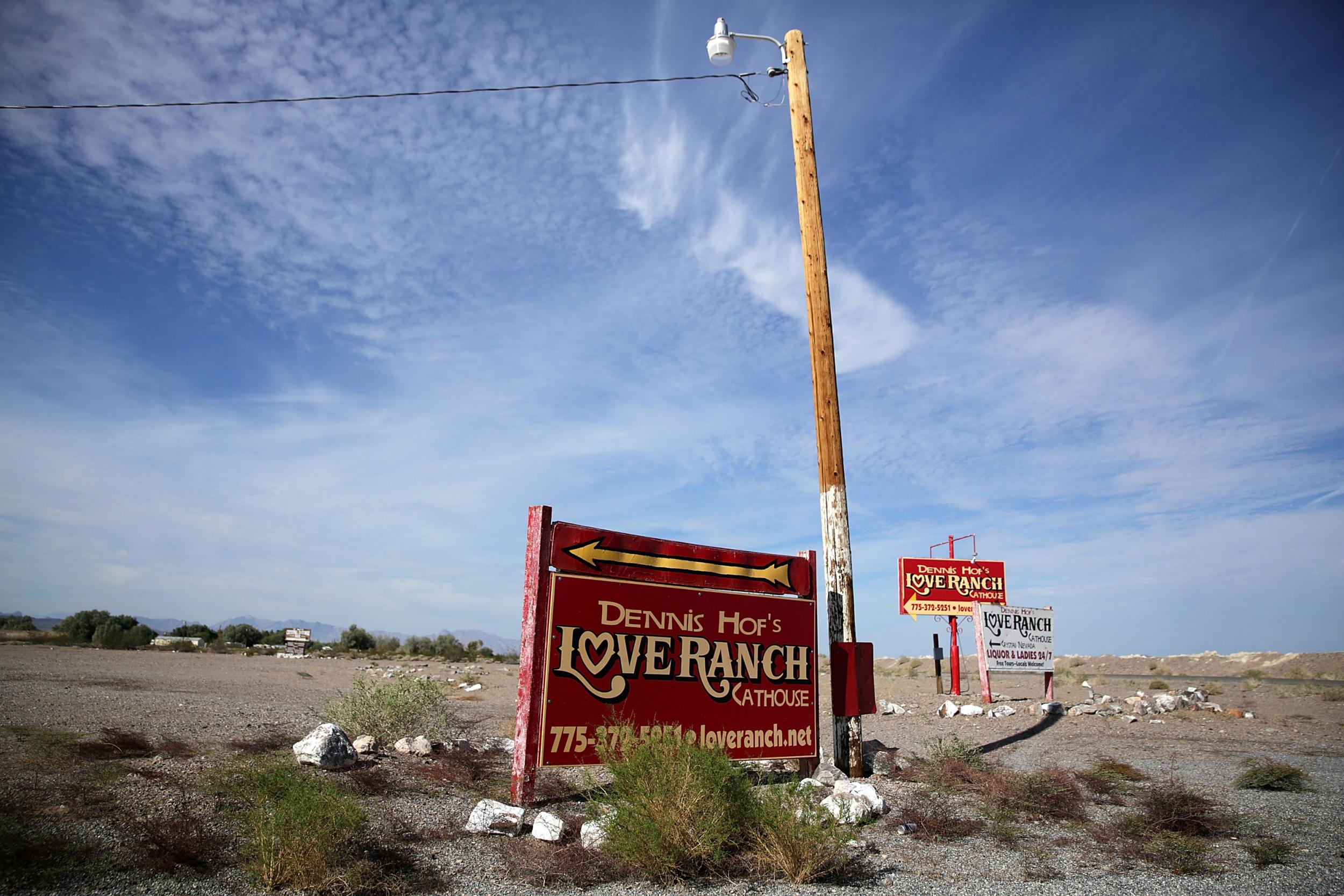 Signs for Dennis Hof's Love Ranch Las Vegas brothel are shown on October 14, 2015 in Crystal, Nevada