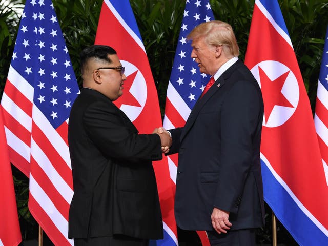 Donald Trump and Kim Jong-un shake hands in Singapore