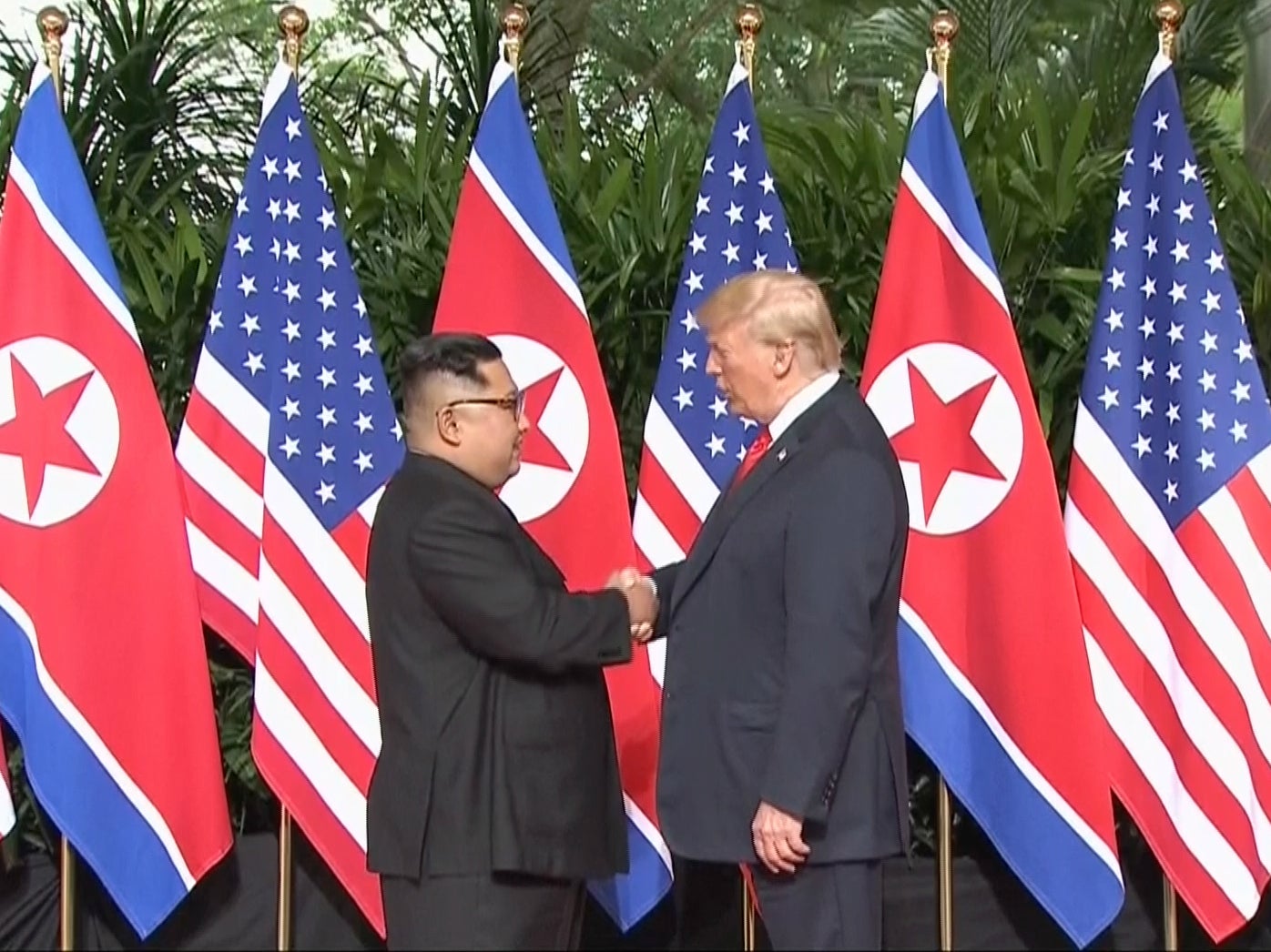 Donald Trump and Kim Jong-un shake hands