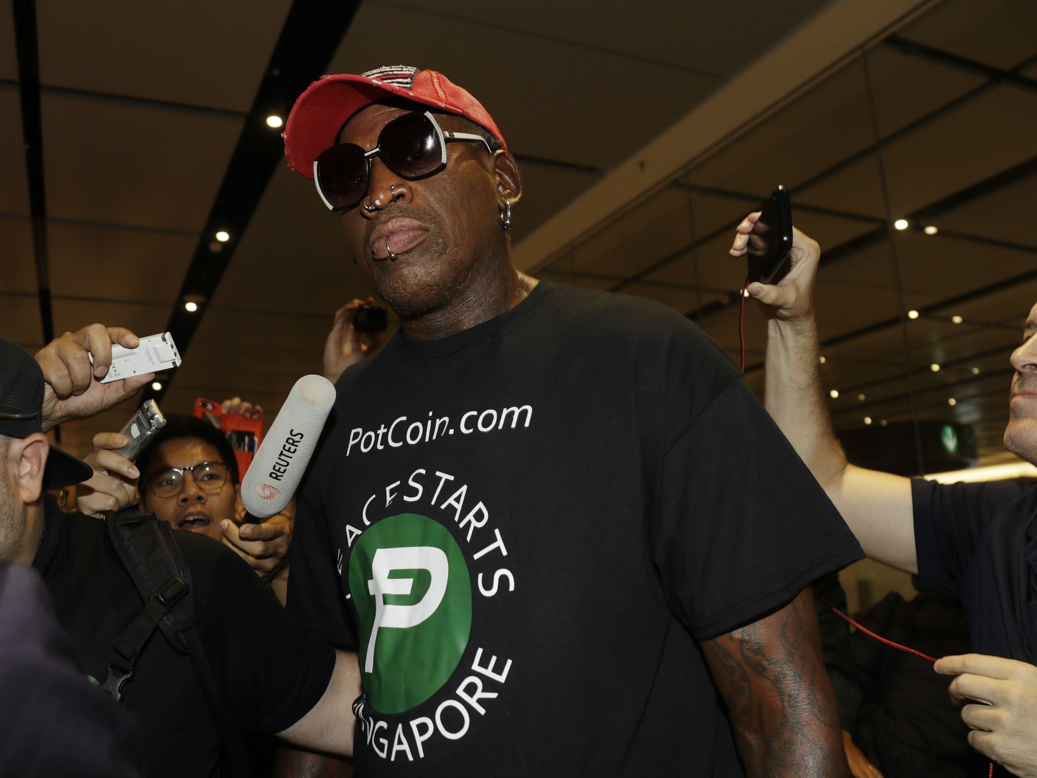 Dennis Rodman arrives at Singapore's Changi Airport  ahead of Donald Trump's summit with Kim Jong-un
