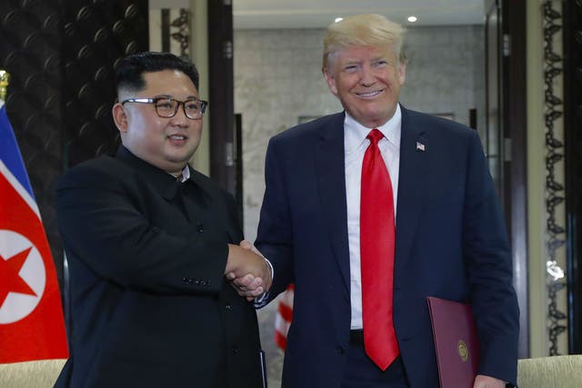 North Korea leader Kim Jong-un and President Donald Trump shake hands after a document signing at the Capella resort in Singapore