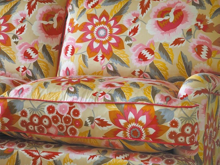 The Miss Clementine three-seater sofa features a floral motif in fiery oranges and reds with clashing pinks (Sofa Workshop )