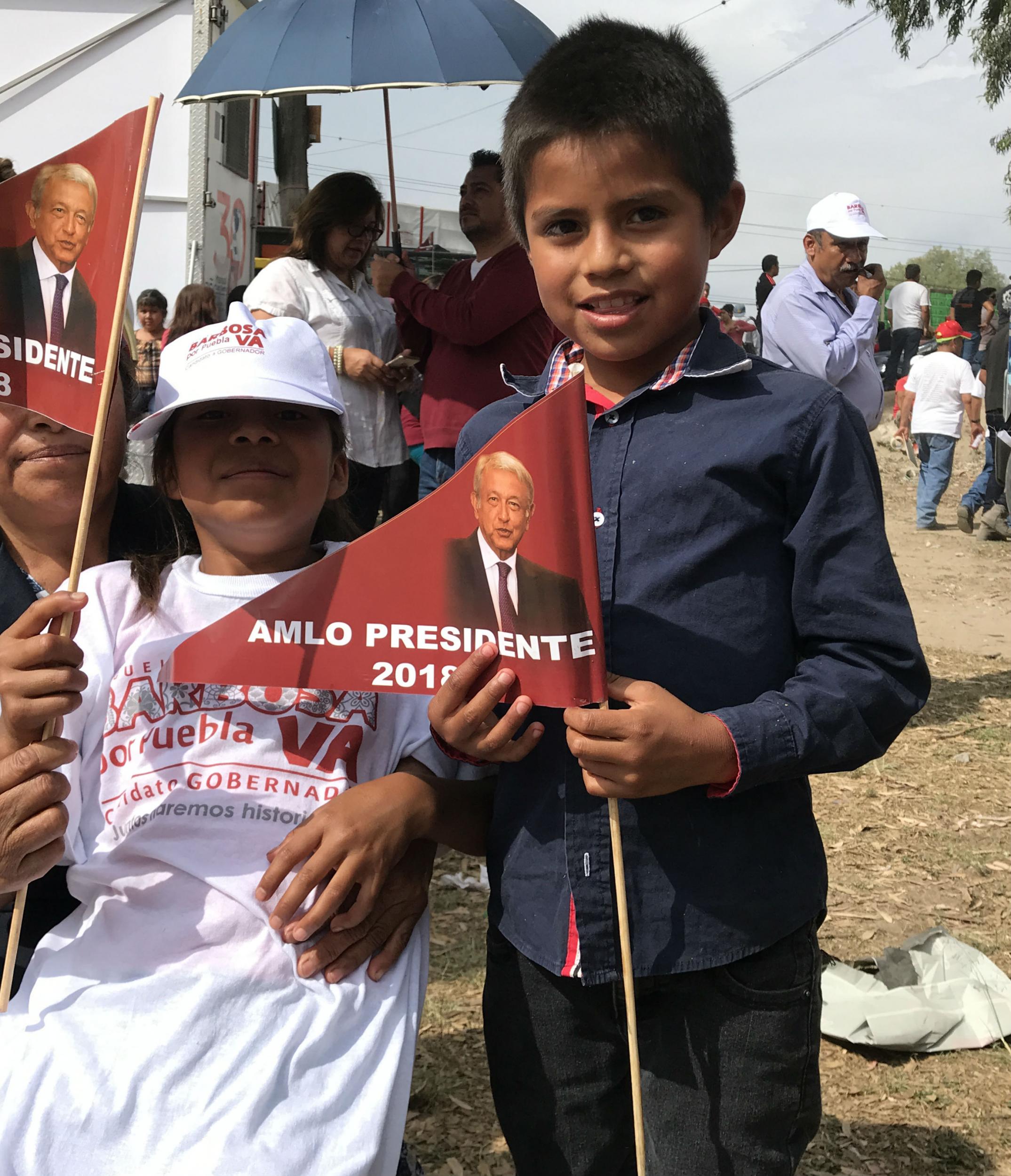 Parents bring their children to the Tecamachalco rally to cheer on AMLO