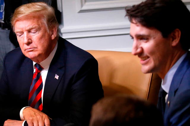 US president Donald Trump listens as he sits beside Canada's prime minister Justin Trudeau during a working session of the G7 Summit in  Quebec, Canada on 8 June 2018