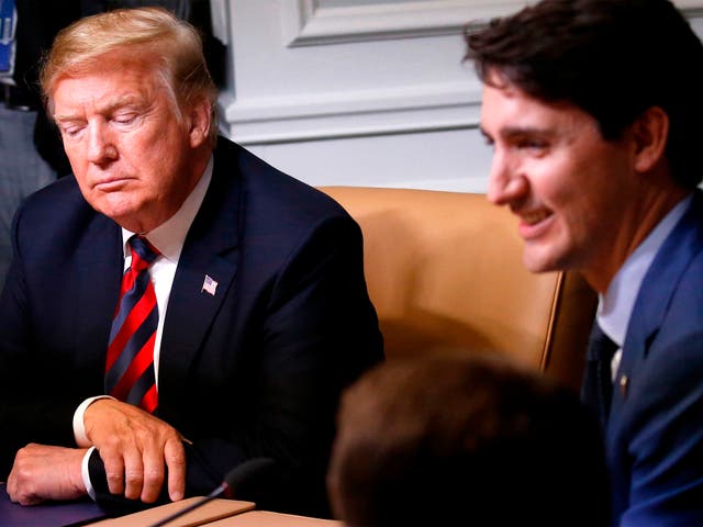 US president Donald Trump listens as he sits beside Canada's prime minister Justin Trudeau during a working session of the G7 Summit in  Quebec, Canada on 8 June 2018