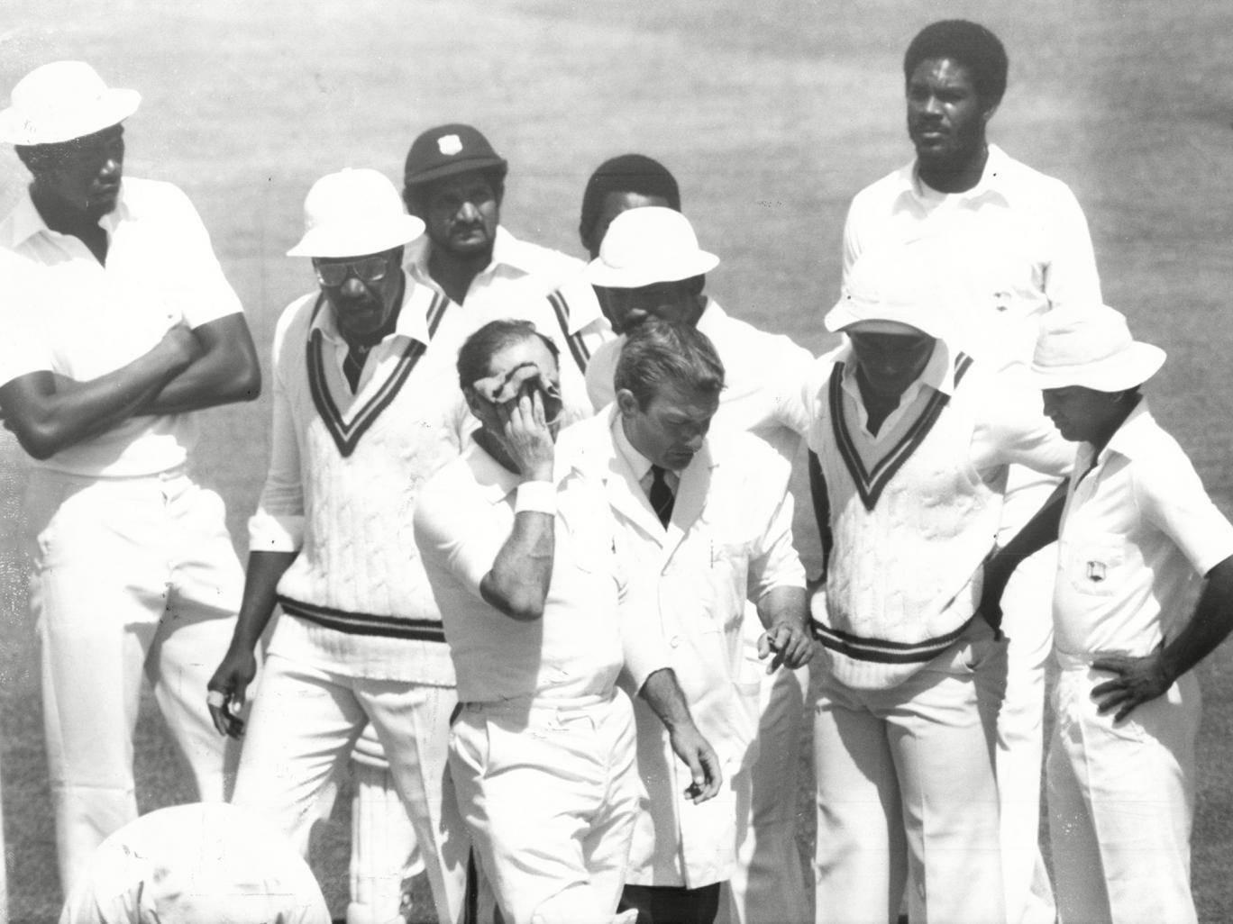 An injured Geoff Boycott is led off by umpire Don Oslear during the fourth Test between England and West Indies at The Oval in 1980