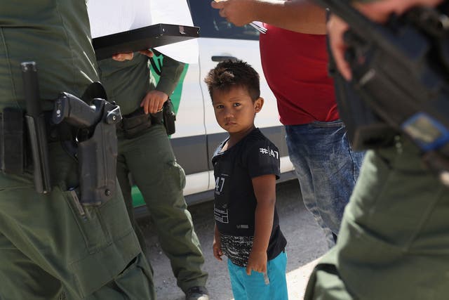 Child among Border Patrol agents at US border with Mexico