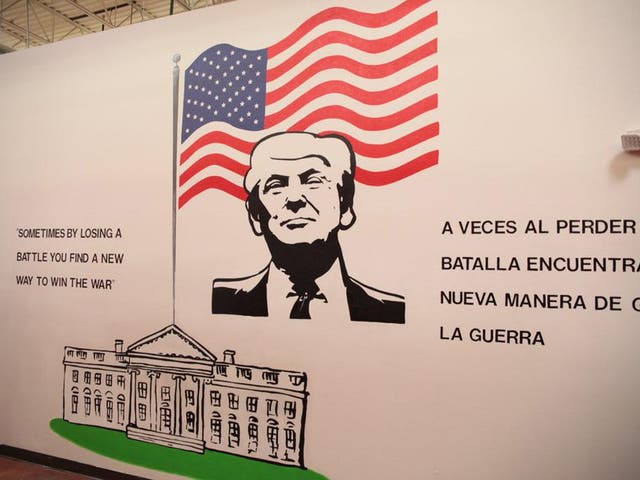 Children arriving at Case Padre are greeted by a mural of Donald Trump