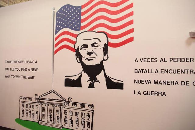 Children arriving at Case Padre are greeted by a mural of Donald Trump