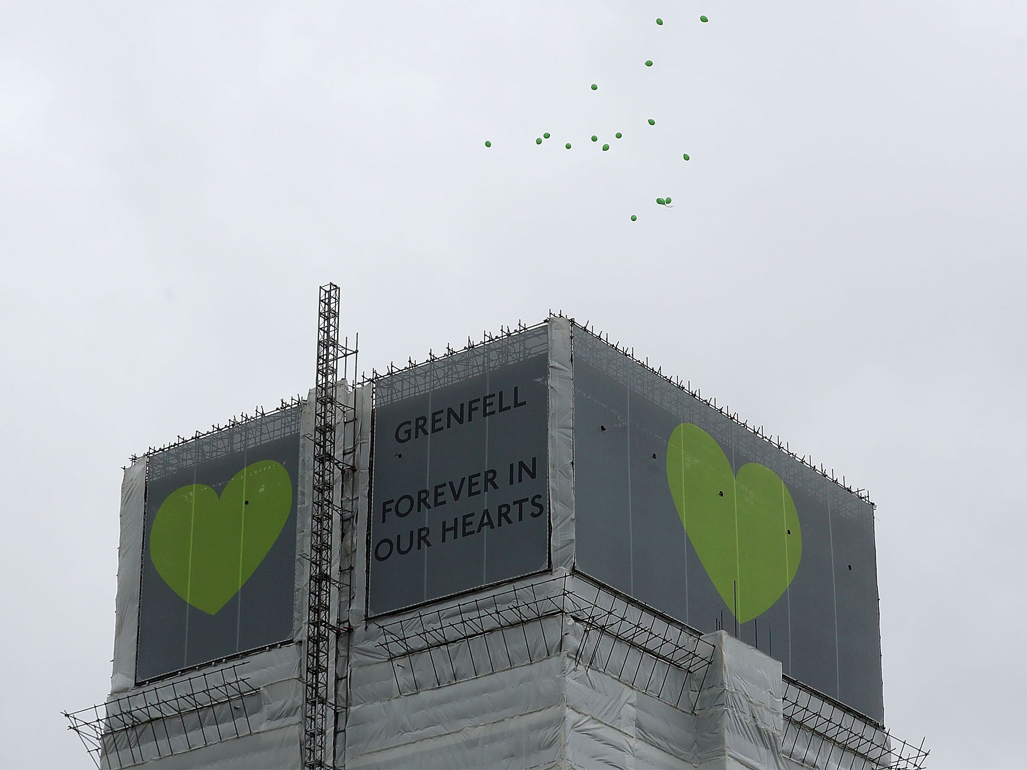Green balloons are released over Grenfell Tower on the one year anniversary of the Grenfell Tower fire on June 14, 2018 in London, England. In one of Britain's worst urban tragedies since World War II, a devastating fire broke out in the 24-storey Grenfell Tower on June 14, 2017 where 72 people died from the blaze in the public housing building of North Kensington area of London.