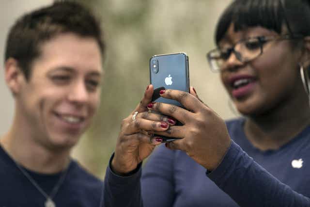 Staff members view the new iPhone X in the Apple store upon its release in the U.K, on November 3, 2017 in London, England