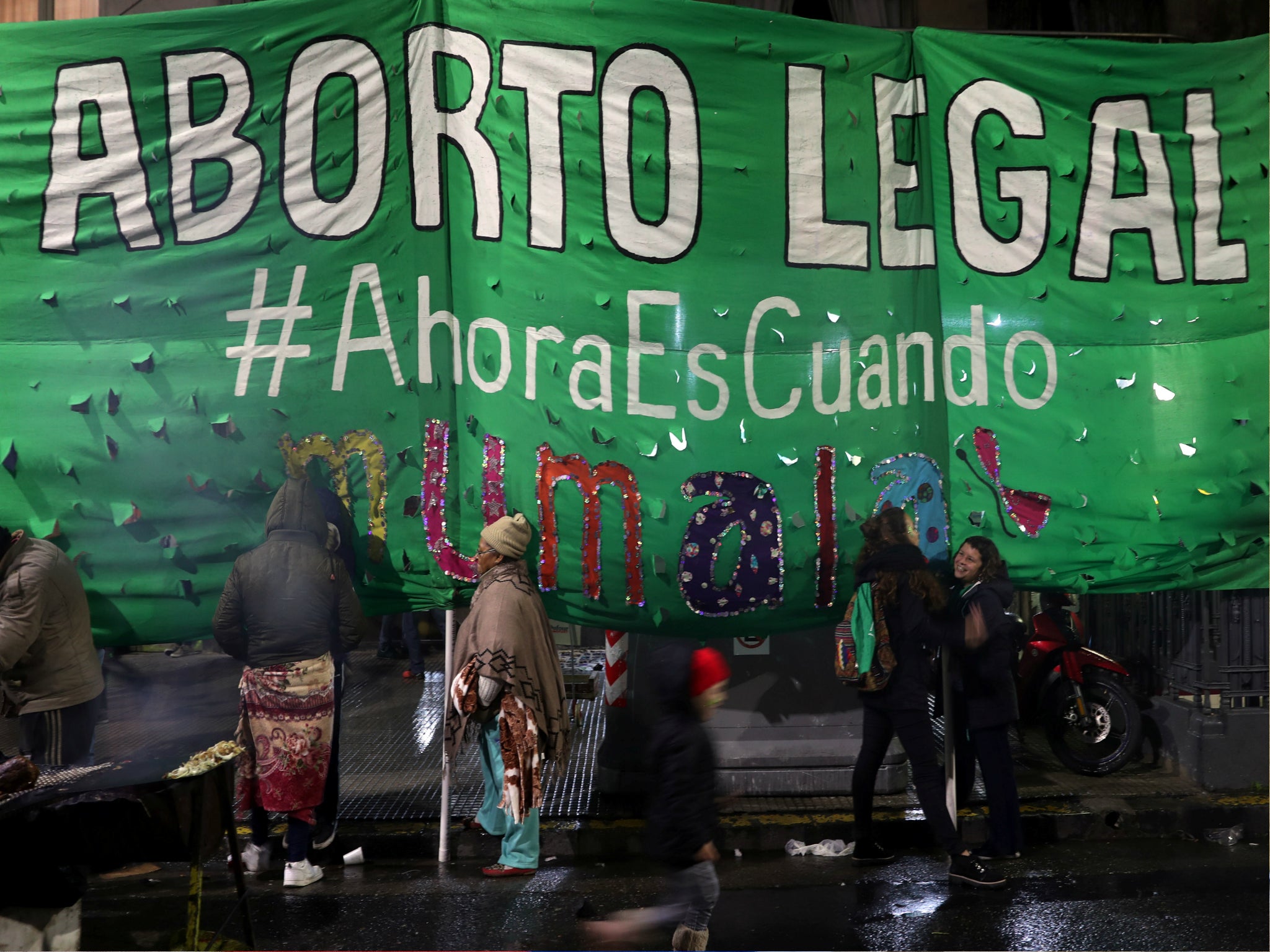 A girl runs in front of a banner that reads "Legal Abortion - Now is when" during a demonstration in favour of legalising abortion outside the Congress in Buenos Aires, Argentina, 31 May 2018.