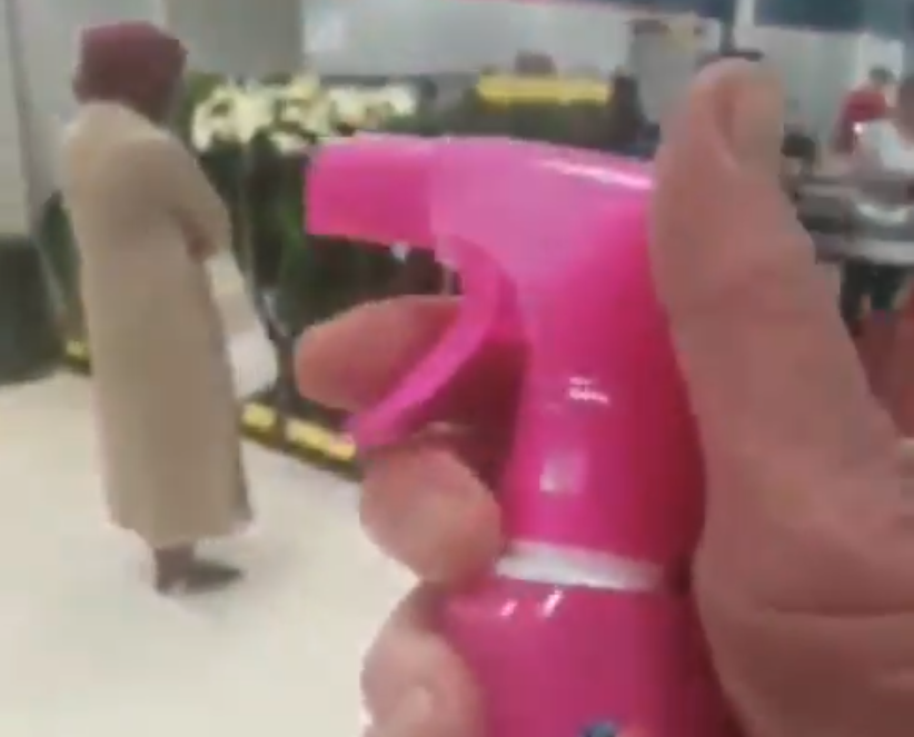 Man appears to spray Muslim woman with stain removal spray in British supermarket