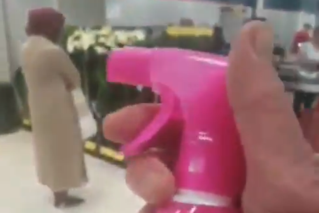 Man appears to spray Muslim woman with stain removal spray in British supermarket