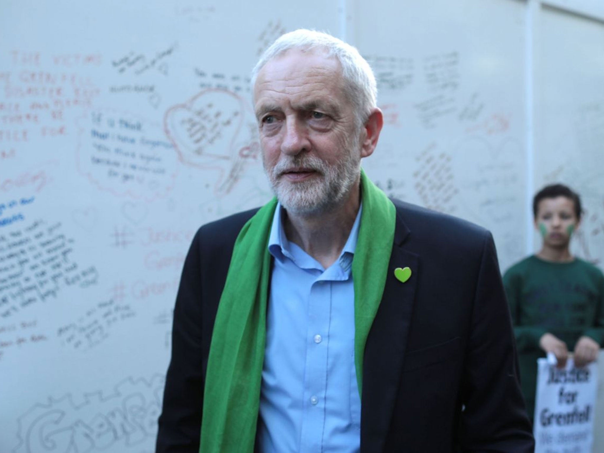Jeremy Corbyn meets members of the public by a memorial wall on the one year anniversary of the Grenfell Tower fire on 14 June, 2018