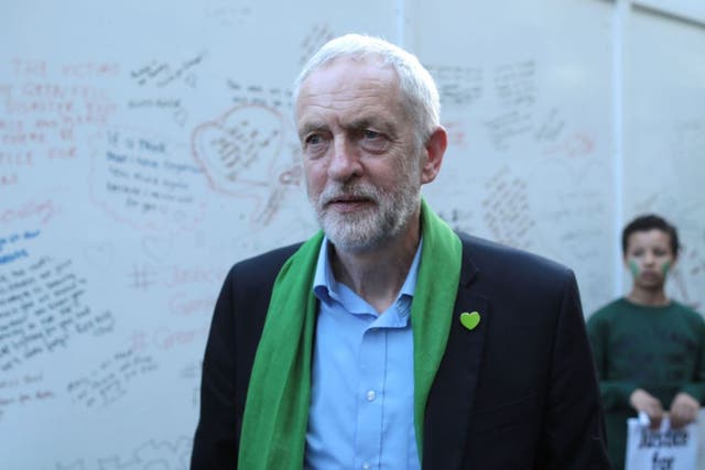 Jeremy Corbyn meets members of the public by a memorial wall on the one year anniversary of the Grenfell Tower fire on 14 June, 2018