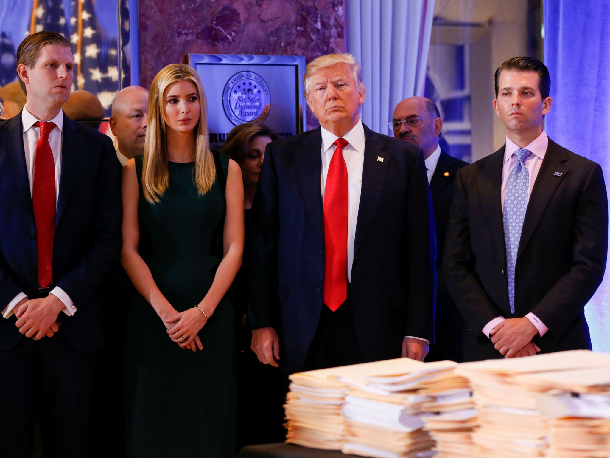 Donald Trump surrounded by his son Eric, left, plus his daughter Ivanka and son Donald Jr, right.