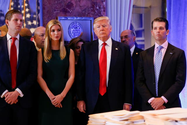 Donald Trump surrounded by his son Eric, left, plus his daughter Ivanka and son Donald Jr, right.