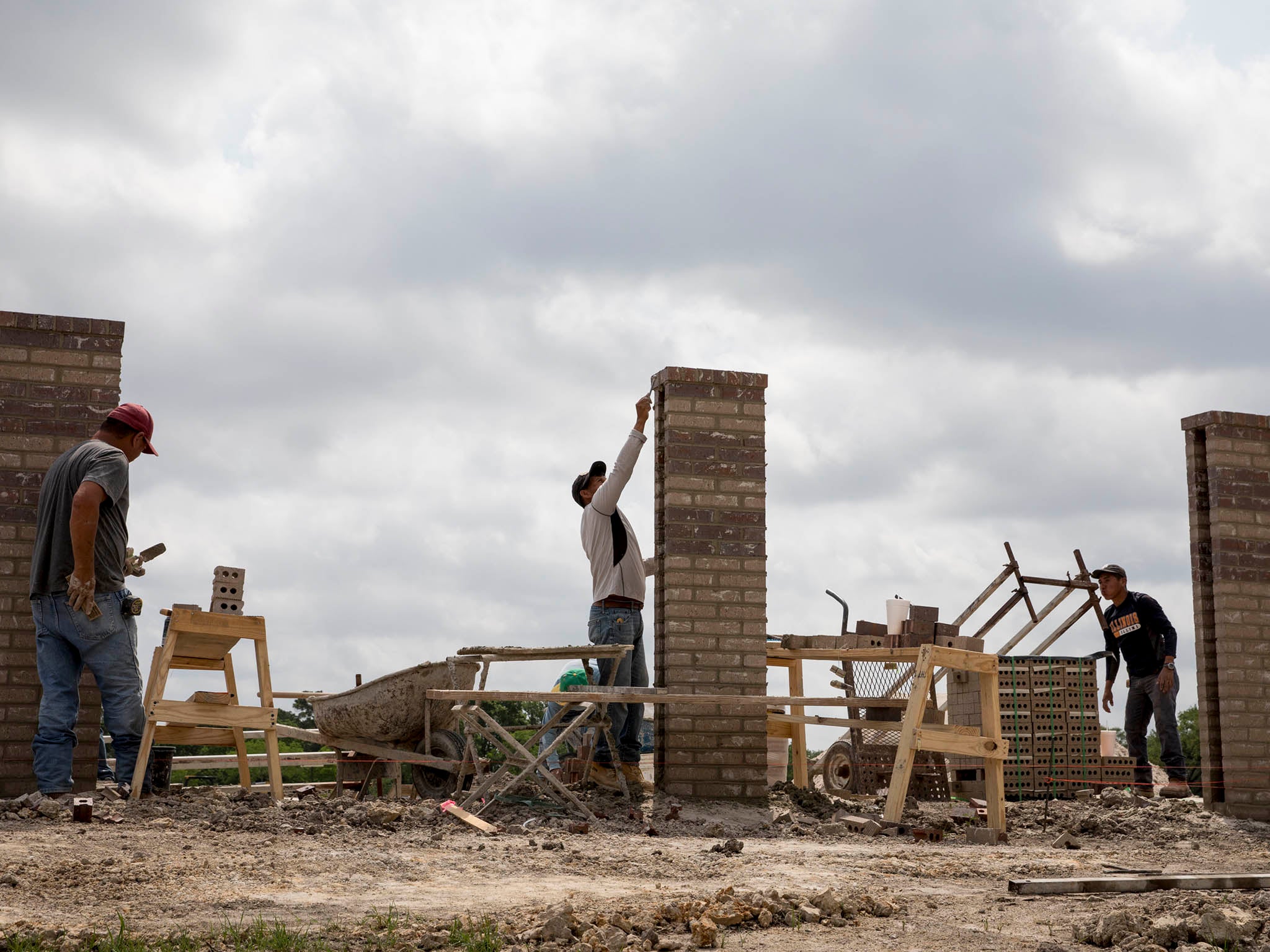 Workers lay bricks at the site of a housing development in Houston (Ilana Panich-Linsman/Washington Post)