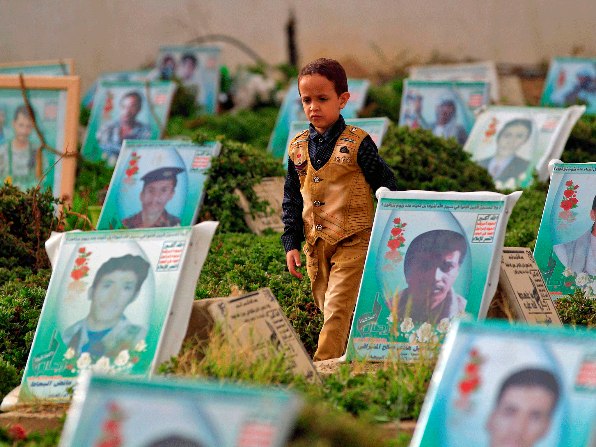 A Yemeni boy walks in a cemetery in the capital Sanaa on 15 June