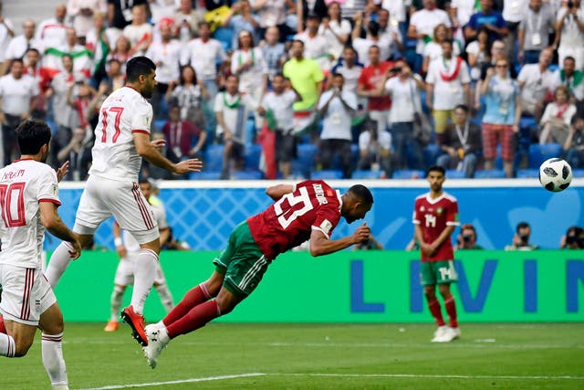 Morocco's forward Aziz Bouhaddouz scores an own goal