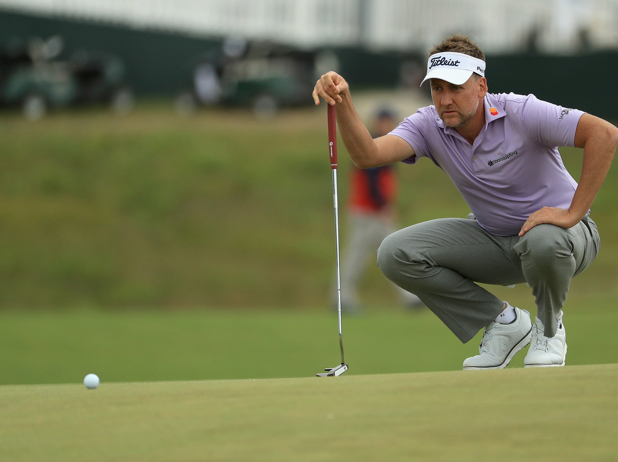 Ian Poulter eyes a putt on the 13th green