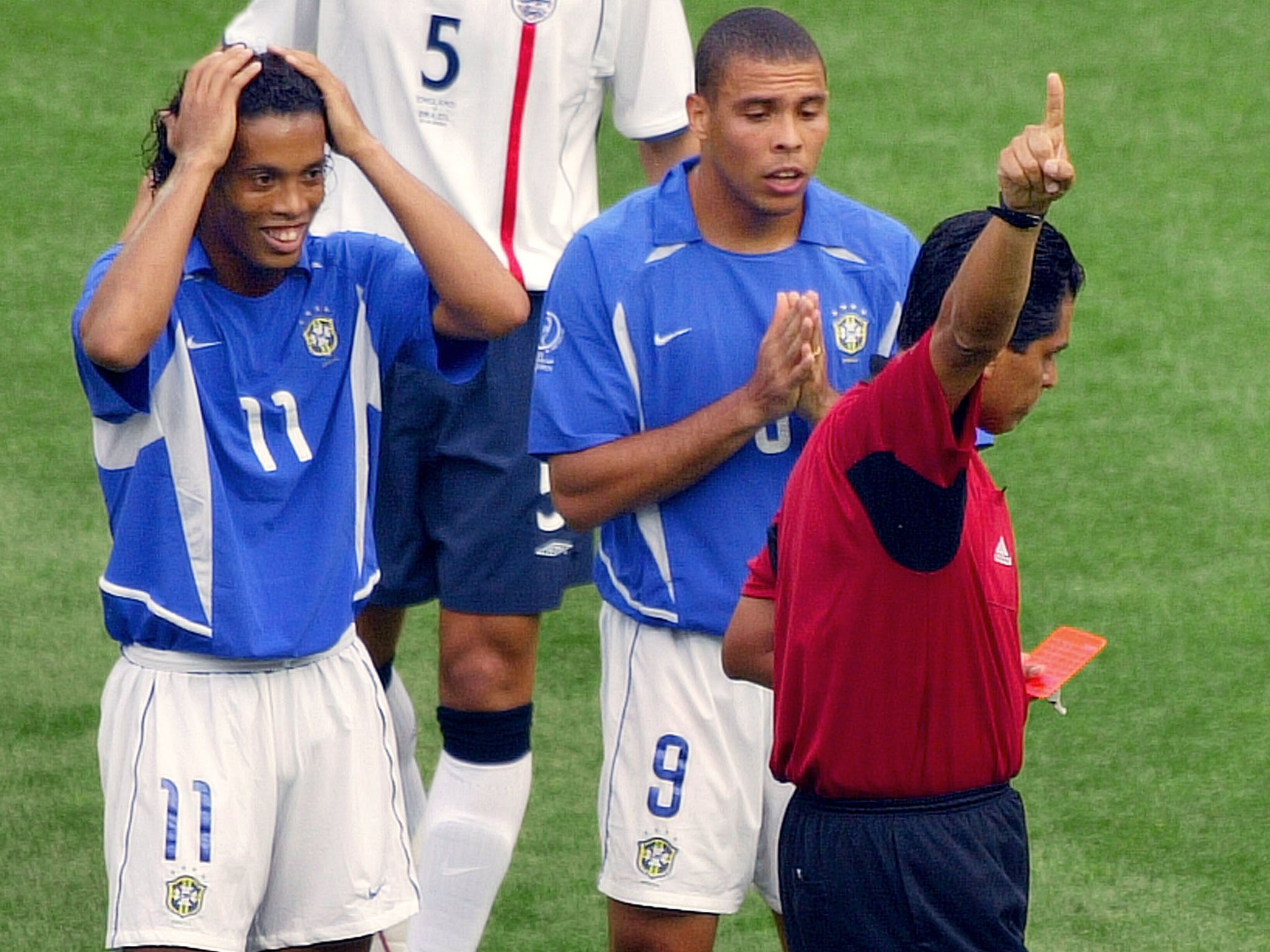 Ronaldinho is shown a straight red card for a loose challenge on Mills