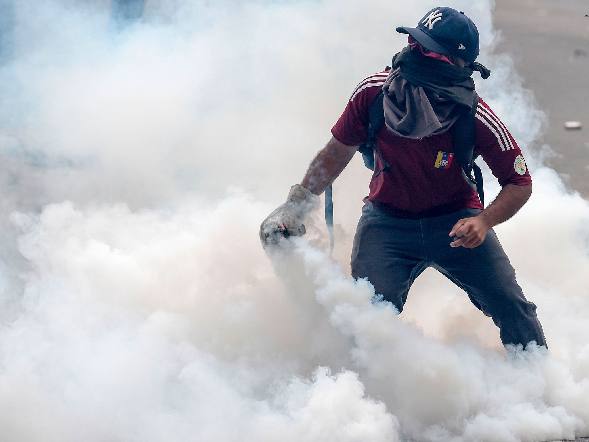 Seventeen people were killed after a tear gas attack. Here, a protester in Caracas holds a canister during a 2017 protest (File photo)