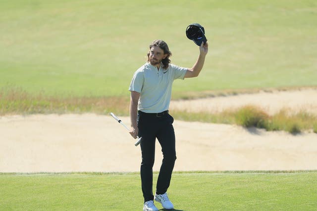Tommy Fleetwood waves to the crowd on the 18th green